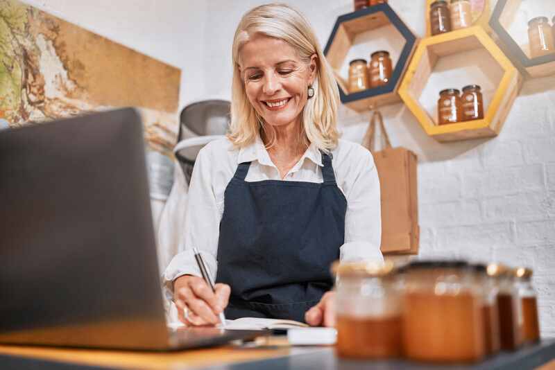 senior woman small business owner organizes finances