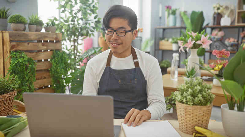 man works on a laptop doing accounting financial planning