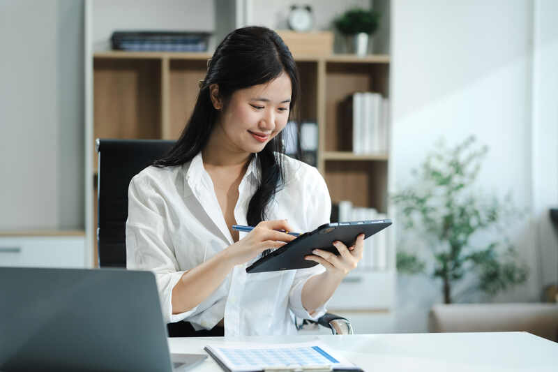 Femme propriétaire d'une petite entreprise travaillant sur un concept de suivi financier ou de comptabilité analytique à l'aide d'un ordinateur portable