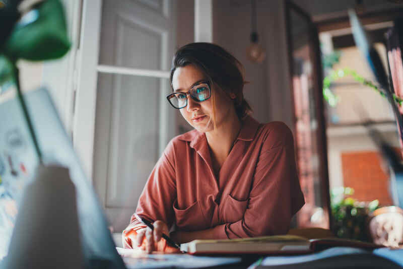 Young architect sitting working with laptop